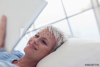 Happy young woman using digital tablet