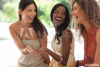 Happy young women looking at engagement ring