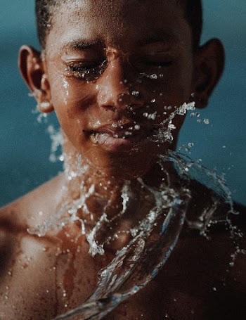 Head Shot Of A Boy With Splash Of Water