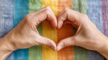 Heart Gesture with Rainbow Flag Background Heart Gesture with Rainbow Flag Background