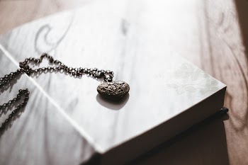 Heart necklace on an open book