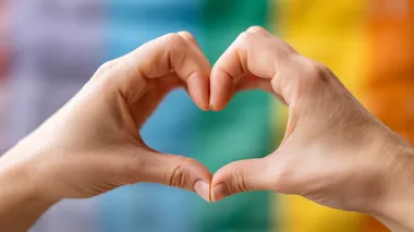 Heart Sign Gesture with Rainbow Flag Background Heart Sign Gesture with Rainbow Flag Background