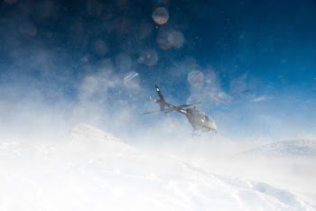 helicopter hovering on snow