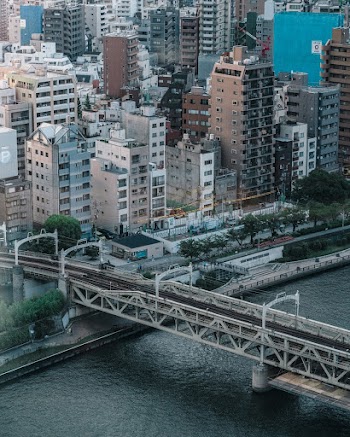 High Angle Photo of Black and White Bridge and City Buildings