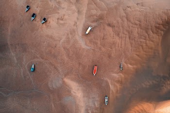 High Angle Photo of Boats During Low Tide