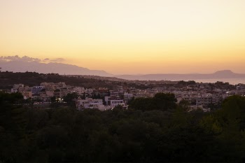 High Angle Photo of Buildings Near Mountain Range and Body of Water