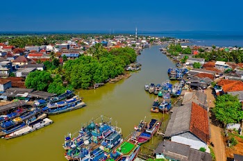 High Angle Photo of City Buildings, Ships, and Lake