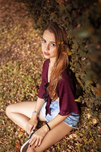 High-Angle Photo of Girl Sitting on Grass