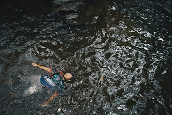 High-Angle Photo of Man Floating on Water