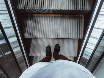 High Angle Photo of Person on Escalator