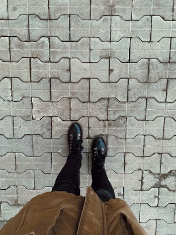 High Angle Photo of Person Standing on Pavement
