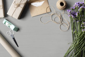 High-angle Photo of Purple Flowers, Brown Yarn and Brown Envelopeon Gray Table