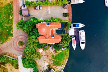 High Angle Photo of Three White boats Beside Brown Building