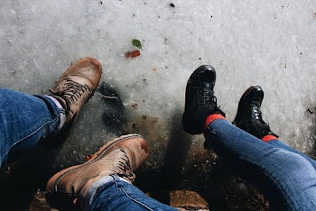 High Angle Photo of Two Person Wearing Leather Boots
