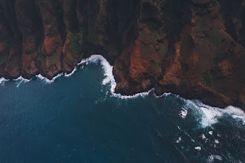 high angle photo of water crashing on mountain