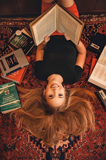 High-Angle Photo of Woman Holding Book