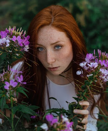 High-Angle Photo of Woman Near Flowers