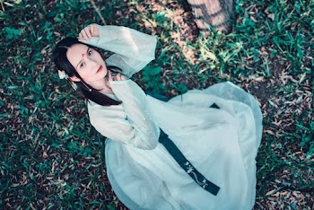 High Angle Photo of Woman Sitting on Grass