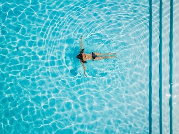 high angle photo woman swimming at body of water