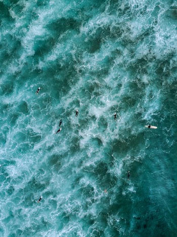 High-angle Photography of People Floating on Body of Water