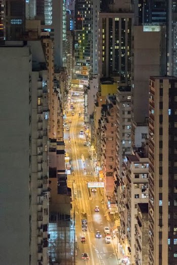 high angle photography of road with cars between buildings