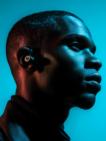 High-Contrast Side-Profile Portrait of a Young Man with Wireless Earbud