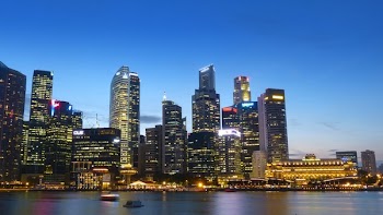 High Rise Building Beside Body of Water during Night Time