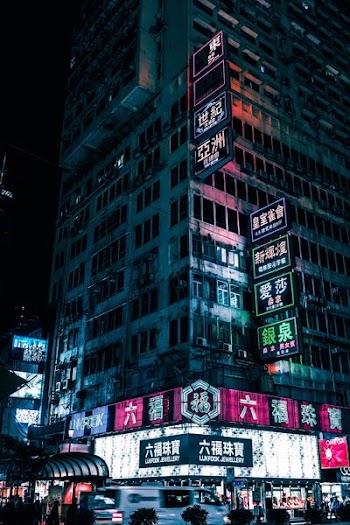 high-rise building with lighted neon signage