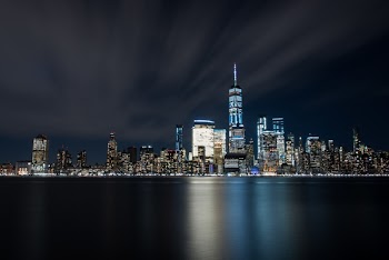 High-rise Buildings at Night Near Sea