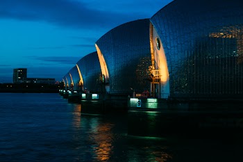 High-rise Buildings Beside Body of Water Under Blue Sky
