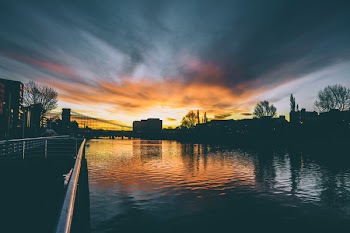High Rise Buildings Near Body of Water during Golden Hour