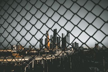 high-rise buildings photo taken in front of fence