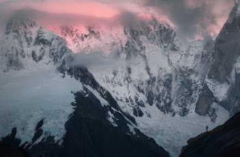 Hiker Standing on Snowy Mountain