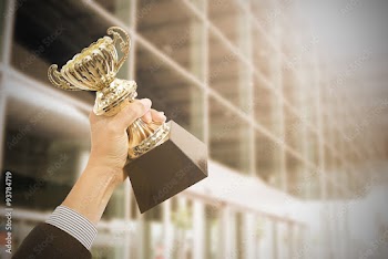 Holding Trophy awards after successful