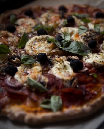 Homemade pizza with mozzarella and basil close up 