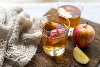 Honey Crisp Apple Beside Two Drinking Glasses