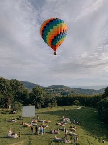 Hot Air Balloon Flying over Green Trees · Free Stock Photo