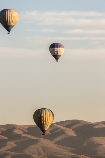 Hot Air Balloons Flying in the Sky over the Mountains