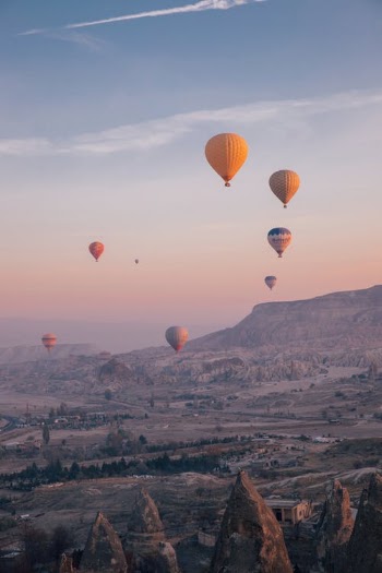 Hot Air Balloons Flying over the Mountains · Free Stock Photo