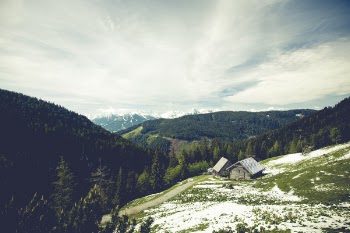 House Beside the Mountain Under White Sky during Daytime