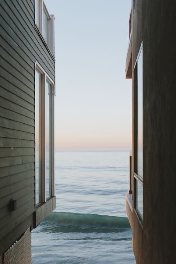 house in front of body of water