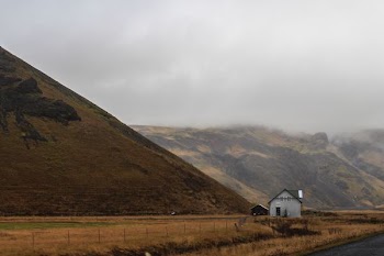 house near misty mountain during daytime