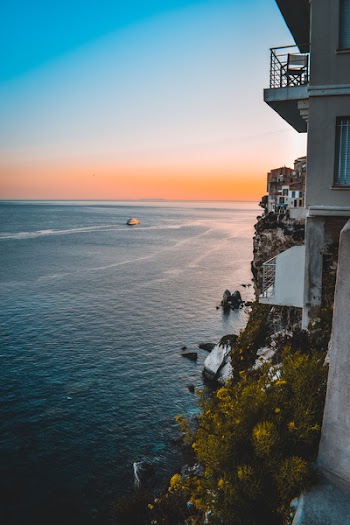 House On Cliff Beside Body Of Water