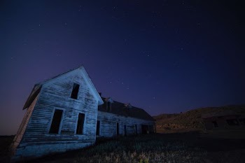 house on field under sky with stars