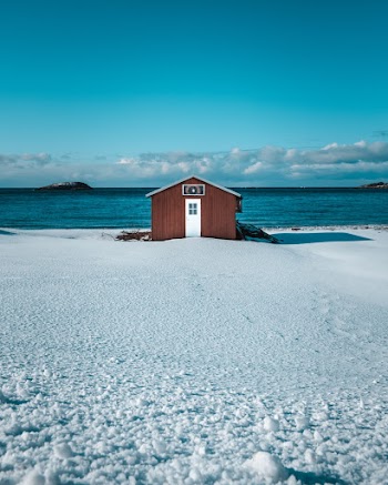 House on Snow Near Body of Water