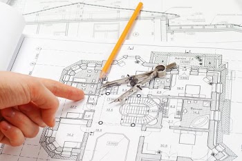 House plan blueprints, designer's hand