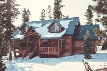 house with snow near the trees