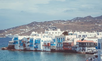 Houses in Between of Mountain and Body of Water