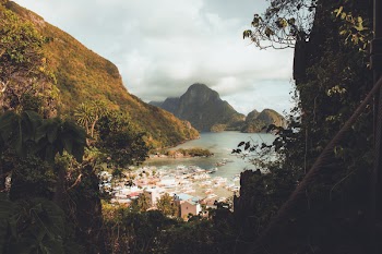 Houses Near Body of Water Surrounded by Moutnains