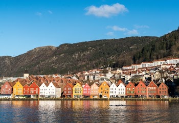 Houses Near Body of Water Under Blue Sky